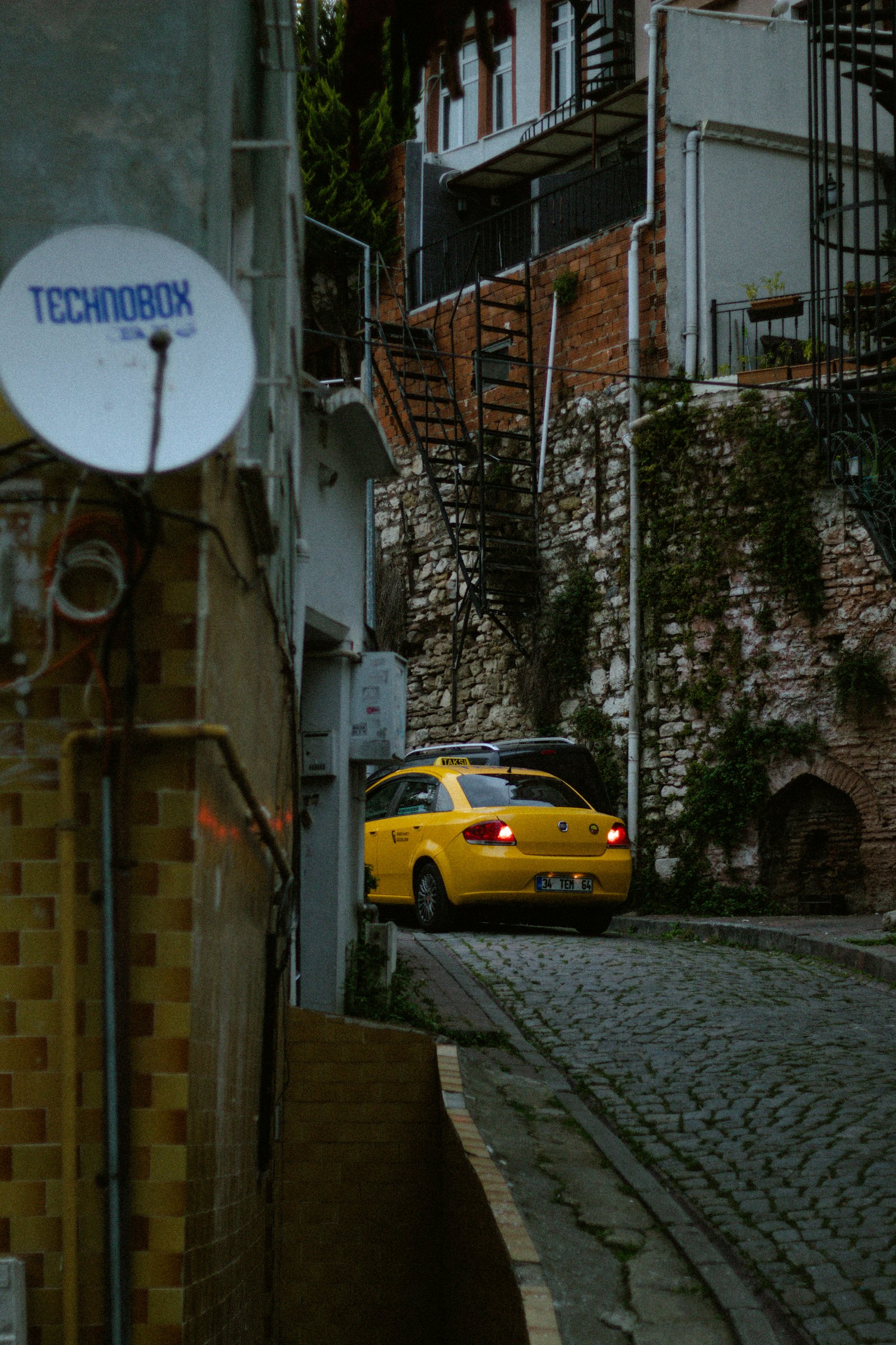Yellow Istanbul taxi on a cobblestone street
